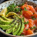 Close-up of a breakfast bowl featuring sliced avocado and smoked salmon.