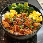 Close-up view of a delicious Chicken Teriyaki Bowl with juicy chicken, broccoli, and pineapple.