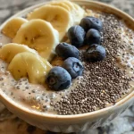 Close-up view of a creamy chia seed pudding topped with fresh fruits.