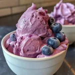 Close-up view of Frozen Blueberry Greek Yogurt Clusters on a textured surface.