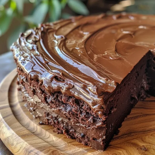 Detailed image of a gluten-free chocolate cake with a soft, fluffy interior and a glossy chocolate frosting.