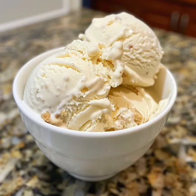 Side view of a spoonful of no-churn vanilla protein ice cream on a vibrant background.