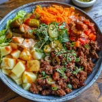 A close-up side view of a Bold Burger Bowl featuring juicy beef, fresh lettuce, and vibrant toppings.