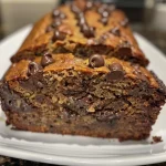 Close-up of moist chocolate chip banana bread, showcasing chocolate chips and banana texture.