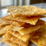 Close-up view of homemade cheese crackers with a golden-brown crust.
