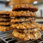 Close-up view of a juicy peanut butter oatmeal cookie with a golden-brown surface.