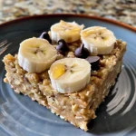 Close-up side view of a Banana Peanut Butter Oatmeal Bar with chocolate chips.