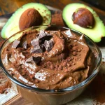Close-up view of a creamy chocolate avocado mousse in a glass bowl.