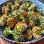 ['Close-up of crispy air fryer broccoli bites, golden and textured.', 'Juicy and crispy frozen broccoli bites in a side view, garnished with seasoning.', 'Deliciously cooked air-fried broccoli florets, showcasing their crispy exterior.', 'Tasty broccoli bites from an air fryer, highlighting their crunchy surface.']