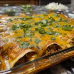 ['Close-up view of Easy Beef Enchiladas topped with melted cheese and fresh cilantro.', 'Juicy Easy Beef Enchiladas placed neatly on a plate, garnished with cilantro.', 'Side view of savory Easy Beef Enchiladas showing layers of beef, sauce, and cheese.', 'Delicious Easy Beef Enchiladas with a rich red sauce and fresh herbs on top.']