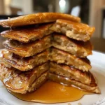 ['Side view of fluffy oat flour pancakes stacked on a plate, drizzled with maple syrup.', 'Close-up of oat flour pancakes topped with syrup, with a light golden hue.', 'Fluffy pancakes made from oat flour, showcasing a soft texture and topped with maple syrup.', 'Delicious stack of oat flour pancakes, highlighting their fluffy appearance and syrup drizzle.']