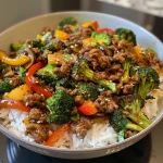 ['Close-up view of a Spicy Ground Beef Stir-Fry Bowl with colorful veggies on a plate.', 'Juicy Spicy Ground Beef Stir-Fry surrounded by vibrant vegetables, presented in a bowl.', 'Side view of a delicious Spicy Ground Beef Stir-Fry Bowl filled with garlic-infused veggies.', 'Appetizing Spicy Ground Beef Stir-Fry with broccoli, bell pepper, and zucchini in a bowl.']