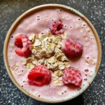 ['Side view of a thick, creamy strawberry oatmeal smoothie in a glass.', 'Close-up of a vibrant strawberry oatmeal smoothie, showcasing its texture and color.', 'A refreshing strawberry oatmeal smoothie with visible fruit pieces in a clear glass.', 'Juicy strawberry oatmeal smoothie decorated with a fresh strawberry on the rim of the glass.']