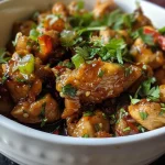 ['Juicy Sweet Chili Chicken with a side of colorful chopped vegetables.', 'Close-up of Sweet Chili Chicken glazed with sauce, served with greens.', 'Tender chicken pieces coated in sweet chili sauce, with diced peppers and onions.', 'Appetizing Sweet Chili Chicken dish featuring vibrant bell peppers and onions.']