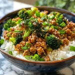 ['A close-up side view of a Teriyaki Turkey Rice Bowl featuring steamed broccoli and ground turkey.', 'Juicy Teriyaki Turkey Rice Bowl with vibrant broccoli and fluffy rice.', 'Side shot of a delicious Teriyaki Turkey Rice Bowl, showcasing its colorful ingredients.', 'Close-up of a rice bowl filled with teriyaki turkey, broccoli, and rice.']