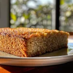 ['Close-up side view of a vanilla oat cake with creamy Greek yogurt frosting.', 'Juicy vanilla oat cake slice displaying fluffy texture and yogurt topping.', 'Side view of a moist vanilla oat cake adorned with a smooth Greek yogurt frosting.', 'A delectable close-up of a vanilla oat cake with a rich Greek yogurt frosting.']