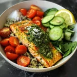 ['Close-up view of vibrant Air Fry Pesto Salmon Bowl with quinoa and fresh vegetables.', 'Delicious Air Fry Pesto Salmon Bowl featuring salmon fillets, quinoa, and colorful veggies.', 'Side view of a nutritious Air Fry Pesto Salmon Bowl with cherry tomatoes, cucumber, and spinach.', 'Appetizing Air Fry Pesto Salmon Bowl showcasing juicy salmon, quinoa, and fresh garnishes.']