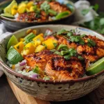 ['A colorful BBQ salmon bowl featuring diced mango and avocado on a bed of rice.', 'Juicy BBQ salmon garnished with fresh salsa made of mango, avocado, and cilantro, served in a bowl.', 'Close-up of a delicious BBQ salmon bowl topped with mango salsa, nestled on a layer of rice.', 'An appetizing view of BBQ salmon, surrounded by vibrant mango and avocado salsa in a bowl.']