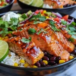 ['A vibrant Chipotle Honey Salmon Bowl featuring salmon fillets glazed with honey and chipotle sauce, served with rice and fresh toppings.', 'Close-up view of a Chipotle Honey Salmon Bowl, showcasing juicy salmon, colorful corn, black beans, and avocado slices.', 'Delicious seafood bowl filled with honey-glazed salmon, rice, sweet corn, and garnished with lime and cilantro.', 'An appetizing presentation of Chipotle Honey Salmon Bowls displaying salmon, creamy avocado, and a sprinkle of sesame seeds.']