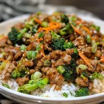 ['A close-up side view of ground turkey teriyaki stir fry, showcasing colorful vegetables and glistening sauce.', 'Juicy ground turkey teriyaki stir fry with broccoli, carrots, and a glossy sauce viewed from the side.', 'Side view of a delicious ground turkey teriyaki stir fry with fresh vegetables and shiny glaze.', 'Close-up image of a stir fry featuring ground turkey, broccoli, and carrots in a teriyaki sauce.']