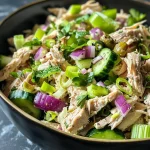 ['Close-up view of a colorful high-protein chicken salad with vibrant ingredients.', 'Juicy shredded chicken salad featuring fresh vegetables and herbs on a plate.', 'Side view of a high-protein chicken salad with greens and creamy dressing highlighted.', 'Detailed image of a delicious chicken salad with chunks of chicken, vegetables, and dressing.']