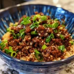 ['Close-up view of a vibrant Korean Beef and Quinoa Bowl garnished with green onions.', 'Juicy Korean Beef served with quinoa and colorful toppings in a rustic bowl.', 'Side view of a delicious Korean dish featuring ground beef and quinoa with spices.', 'A hearty meal of Korean Beef and Quinoa presented in a textured bowl with visible ingredients.']