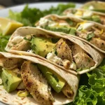 ['Close-up view of juicy Lemon Pepper Chicken Wraps with vibrant toppings.', 'Side-angle shot of Lemon Pepper Chicken Wraps showcasing fresh ingredients.', 'Detailed image of Lemon Pepper Chicken Wraps filled with chicken, cheese, and vegetables.', 'Appetizing photo of Lemon Pepper Chicken Wraps highlighting lemon zest and green sprouts.']