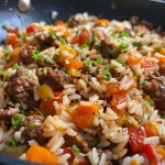 ['Close-up view of a creamy One Pot Cheesy Cajun Beef Rice dish, showcasing colorful ingredients.', 'Plate filled with One Pot Cheesy Cajun Beef Rice, highlighting the melting cheese and beef mince.', 'Side view of a hearty One Pot Cheesy Cajun Beef Rice, with vibrant vegetables and cheese texture.', 'Delicious One Pot Cheesy Cajun Beef Rice, emphasizing its cheesy top and rich colors.']
