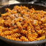 ['Juicy One Pot Ground Turkey Pasta with vibrant colors and ingredients visible.', 'A dish of One Pot Ground Turkey Pasta showcasing cooked pasta, ground turkey, and tomato sauce.', 'Close-up of a hearty serving of ground turkey pasta, featuring fresh herbs and cheese garnish.', 'Delicious One Pot Ground Turkey Pasta served in a bowl, highlighting the textures and ingredients.']