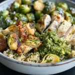 ['Close-up view of a colorful Pesto Turkey Quinoa Bowl with Brussels sprouts.', 'A delicious Pesto Turkey Quinoa Bowl showcasing quinoa, ground turkey, and Brussels sprouts.', 'Side view of a vibrant bowl filled with quinoa, pesto, turkey, and fresh Brussels sprouts.', 'Detailed shot of a Pesto Turkey Quinoa Bowl featuring juicy turkey and halved Brussels sprouts.']