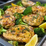 ['Close-up view of golden brown Sheet-Pan Lemon-Garlic Chicken with vibrant green broccoli florets.', 'Juicy chicken thighs glistening with lemon and garlic, surrounded by fresh broccoli on a sheet pan.', 'A side angle of cooked lemon-garlic chicken next to steamed broccoli, showcasing delicious presentation.', 'Close-up of crispy chicken and bright broccoli, drizzled with olive oil and lemon juice.']