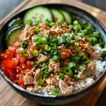 ['A vibrant Spicy Tuna Rice Bowl featuring colorful ingredients in a close-up view.', 'A delicious bowl of Spicy Tuna Rice, showcasing fresh vegetables and garnishes.', 'An appetizing side view of a Spicy Tuna Rice Bowl with a variety of textures and colors.', 'A close-up of a Spicy Tuna Rice Bowl filled with tuna, rice, and fresh toppings.']