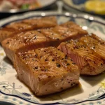 ['Juicy tuna steaks marinated in honey mustard, glistening with a golden glaze.', 'Close-up view of perfectly cooked tuna steaks with a honey mustard marinade on a plate.', 'Tender tuna steaks garnished with herbs, showcasing a rich honey mustard glaze.', 'Freshly grilled tuna steaks highlighted by a vibrant honey mustard marinade.']