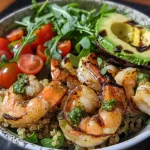 ['Close-up view of a vibrant charred shrimp quinoa bowl with arugula and cherry tomatoes.', 'Side perspective of a colorful bowl featuring grilled shrimp, avocado, and quinoa.', 'Detailed image of a charred shrimp quinoa bowl, showcasing fresh ingredients and bright colors.', 'Appetizing close-up of a shrimp and quinoa dish arranged beautifully with greens and tomatoes.']
