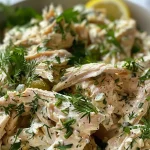 ['A close-up view of a vibrant Zingy Herbed Chicken Salad featuring shredded chicken and fresh herbs.', 'Juicy Zingy Herbed Chicken Salad displayed in a bowl, showcasing colorful ingredients like dill, chives, and capers.', 'Side view of a serving of Zingy Herbed Chicken Salad, highlighting its creamy texture and fresh herbs.', 'A detailed look at a bowl of Zingy Herbed Chicken Salad, filled with shredded chicken, herbs, and vegetables.']