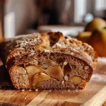 ['Close-up view of apple cinnamon sourdough bread with a golden crust.', 'Side view of a loaf of apple cinnamon sourdough, showcasing its texture and ingredients.', 'Appetizing slice of apple cinnamon sourdough highlighting juicy apple pieces and a cinnamon swirl.', 'Freshly baked apple cinnamon sourdough with a rustic appearance and warm color.']