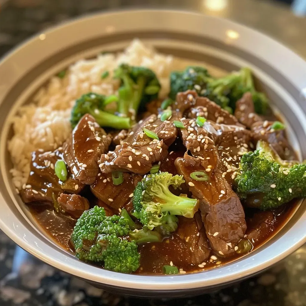 ['Close-up view of Crockpot Beef and Broccoli with vibrant green broccoli and tender beef strips.', 'Juicy Crockpot Beef and Broccoli served in a bowl, showcasing tender meat and bright broccoli florets.', 'Side view of a serving of Crockpot Beef and Broccoli, highlighting its glossy sauce and fresh garnishes.', 'A delicious medley of beef and broccoli in a savory sauce, presented in a rustic bowl.']