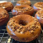 ['Close-up view of a gluten-free Pumpkin Spice Protein Donut with a golden-brown glaze.', 'Side view of a fluffy Pumpkin Spice Protein Donut, showcasing its texture and toppings.', 'A deliciously spiced Pumpkin Protein Donut displayed on a rustic background.', 'Horizontal shot of a Pumpkin Spice Donut sprinkled with cinnamon, highlighting its moist interior.']