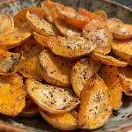 ['Close-up of roasted butternut squash seeds with a golden brown sheen.', 'A side view of crunchy, seasoned butternut squash seeds on a wooden surface.', 'Freshly roasted butternut squash seeds sprinkled with spices and glistening.', 'A collection of delicious roasted butternut squash seeds arranged appetizingly.']