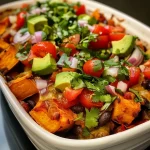 ['A close-up side view of a colorful Sweet Potato Black Bean Casserole displaying layers of sweet potato, black beans, and vibrant vegetables.', 'A delicious Sweet Potato Black Bean Casserole with visible layers of ingredients, showcasing sweet potato slices, black beans, and chopped tomatoes.', 'An appetizing side view of Sweet Potato Black Bean Casserole featuring a mix of textures from sweet potatoes, black beans, and fresh herbs.', 'A close-up image of Sweet Potato Black Bean Casserole highlighting its rich colors and ingredients like red bell pepper and cheddar cheese.']