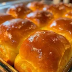 ['Close-up of golden-brown sweet potato dinner rolls, showcasing a soft, fluffy texture.', 'Side view of freshly baked sweet potato dinner rolls, highlighting their warm, inviting color.', 'Juicy sweet potato dinner rolls with a shiny crust, emphasizing their homemade appeal.', 'A delicious stack of sweet potato dinner rolls, revealing their fluffy interior and rich hue.']
