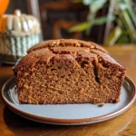 ['Close-up side view of a slice of gluten-free pumpkin bread with chocolate and cinnamon swirl.', 'Juicy, moist gluten-free pumpkin bread slice showcasing a chocolate cinnamon swirl pattern.', 'Side view of a thick slice of pumpkin bread featuring rich chocolate and cinnamon swirls.', 'Detailed close-up of a gluten-free pumpkin bread slice with a glossy chocolate cinnamon swirl.']