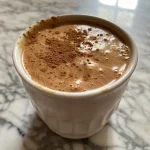 ['Close-up view of a Protein Chai Latte Mix with ingredients visible, taken with an iPhone 15 Pro.', 'Detailed side view of a Protein Chai Latte Mix showing ingredients and a creamy texture.', 'Bright close-up of Protein Chai Latte Mix featuring spices and protein powder in a clear glass.', 'A vibrant close-up of Protein Chai Latte Mix with almond milk in a well-lit setting.']
