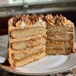 A close-up side view of a moist Chai Layer Cake featuring rich layers and frosted edges.