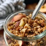 Close-up view of apple cinnamon granola showcasing oats and apple chips.