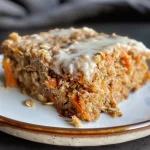 A moist protein carrot cake with grated carrots and chopped pecans.
