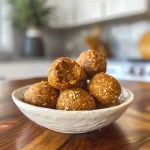 Close-up view of a pumpkin protein ball, showcasing its textured surface.