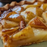 A side view of a golden brown Spiced Poached Pear Galette with juicy pears.
