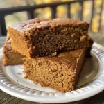 Close-up view of a slice of sugar-free pumpkin gingerbread, showcasing its moist texture and spices.