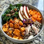 Close-up view of a colorful grain bowl filled with wild rice, quinoa, sweet potatoes, and greens.